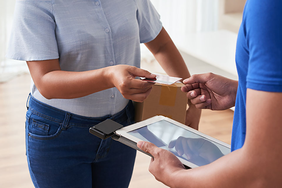 A business woman receiving parcel from a courier guy