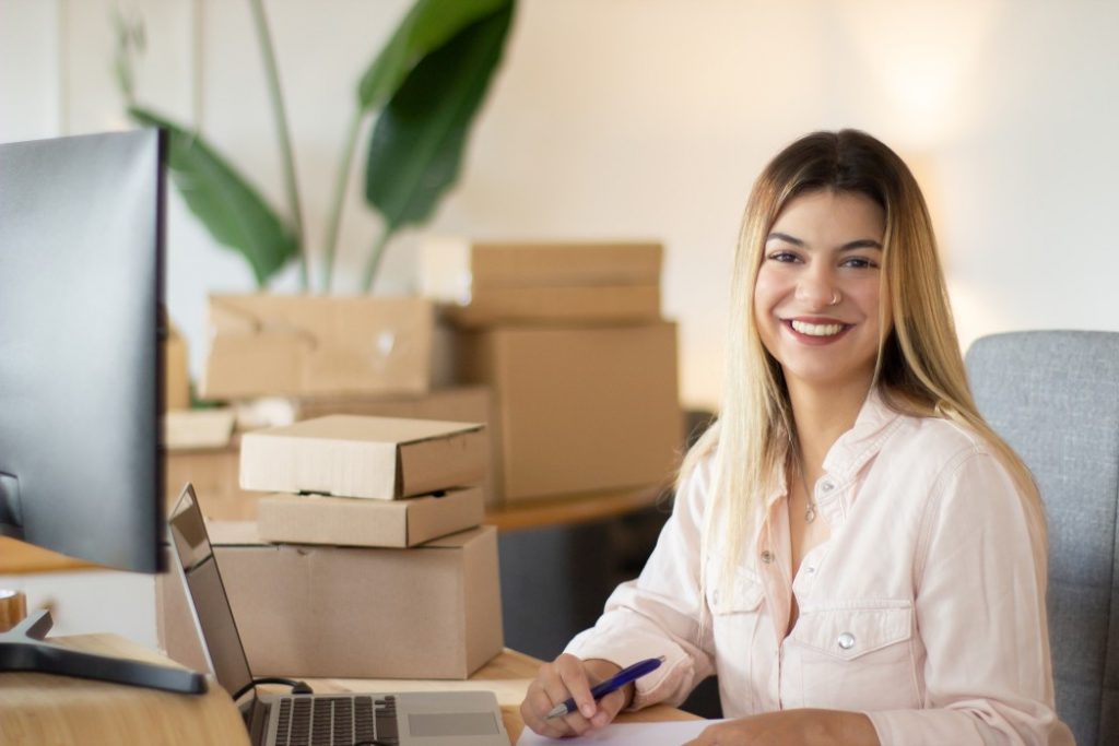 A buinesswoman working on laptop and handling her ecommerce store orders